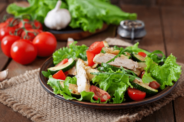 Salad with chicken and vegetables is a great option for a light dinner after training. 